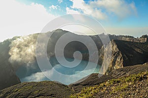 Volcanic lakes Ato Polo and Nuamuri koofai . National park Kelimutu. Kelimutu tri coloured volcano crater covered with photo