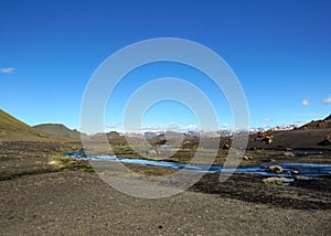 Volcanic landscape with glacial river running from Myrdalsjokull glacier, Hvanngil, Laugavegur Trail, highlands of Iceland