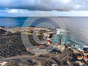 Volcanic landscape with lighthouse and salt production facility. La Palma island, aerial view