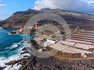 Volcanic landscape with lighthouse and salt production facility. La Palma island, aerial view