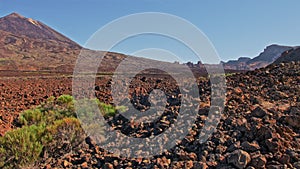 Volcanic landscape. Red stone rock and peak hill in the background. It can be used to illustrate life on Mars, landing