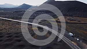 Volcanic landscape viewed from drone with holes to produce wine in agriculture business. Vineyard on volcan sand. Amazing