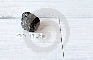 Volcanic Lapillus on white wood table photo