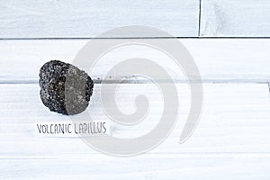 Volcanic Lapillus on white wood table photo