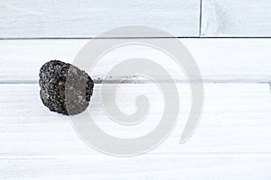 Volcanic Lapillus on white wood table