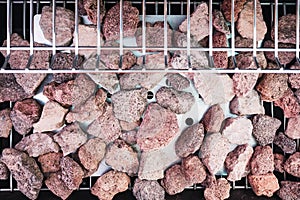 Volcanic lava rocks on a barbecue to transmit the heat of the flame