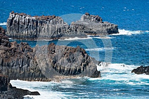 Volcanic lava rocks in the water, typical of El Hierro island. Canary Islands