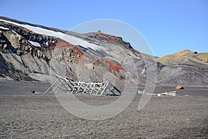 Volcanic mountains of Deception Island, Antarctica. Small sunken timber beams of abandoned whale station, Lost places,