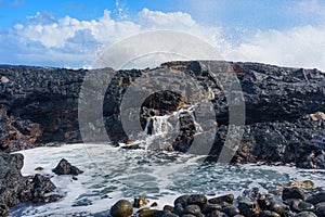 Volcanic Rocks on Hawaiian Coastline with Ocean Wave