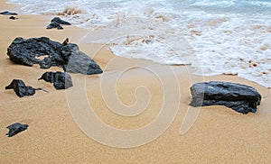 Volcanic rocks on the sands of Maui, Hawaii