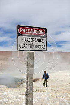 Volcano danger warning sign post in Solar de Manana geyser, Boli photo
