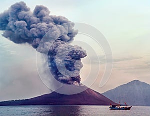 Volcano eruption. Boat near volcano Anak Krakatau, Indonesia photo