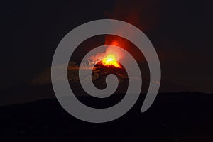 Volcano eruption in the evening seen from afar Etna eruption from the crater Laterala view at night with a grade glow of fiery lav photo