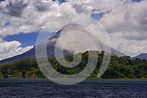 Volcano with exhalation and ash. Beautiful tropic landscape with volcano. Cone active volcano, Central America. Active Arenal with