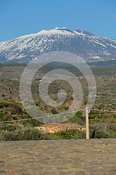 The volcano Mount Etna seen from Bridge of the Saracens, near Adrano town, Sicily, Italy