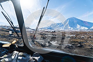 A volcano from the window of an all-terrain vehicle