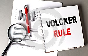 VOLCKER RULE text written on notebook with chart