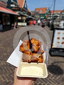 Volendam, Amsterdam/Netherlands-June 25, 2019: Delicious fried fish named kibbeling, served with tartar sauce in Volendam