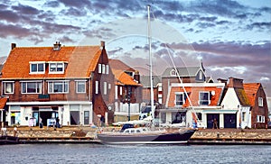 Volendam, Amsterdam, Netherlands. Luxury yachts by piers. Sea photo