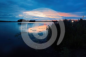 The Volga River in the first minutes of the morning sunrise. The bank, overgrown with reeds, can be seen in the background of