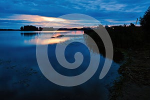 The Volga River in the first minutes of the morning sunrise. The bank, overgrown with reeds, can be seen in the background of