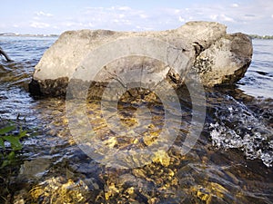 Volga river.  View of river stones on a sunny day with waves