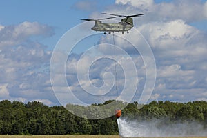 Volkel Netherlands June 13 2019: Royal Netherlands Air Force Chinook demonstrating firefighting with a Bambi bucket