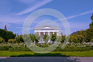 Volksgarten Public Park in Vienna, view on Theseus temple. Column Hall in the garden with beautiful colorful landscape