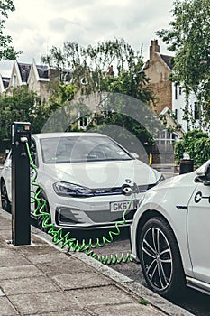 Volkswagen Golf GTE charging at a charging point on a street in London