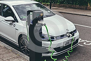 Volkswagen Golf GTE charging at a charging point on a street in London