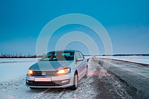 Volkswagen Polo Car Sedan Vento Parking On A Roadside Of Country Road On A Background Of Dramatic Sunset Sky At Winter