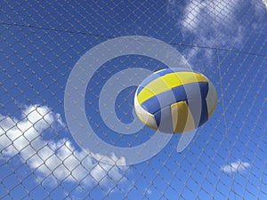 Volleyball ball in the air over wire fence background photo