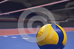 Volleyball ball on blurred wooden parquet background