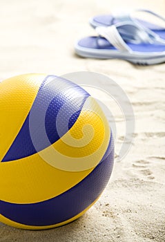 Volleyball ball and flip-flops