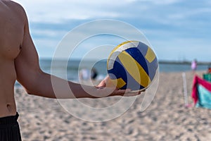 volleyball ball in the hands of a man