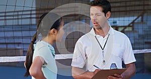 Volleyball coach assisting female player on clipboard 4k