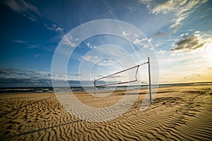 Volleyball court on the beach in sunset
