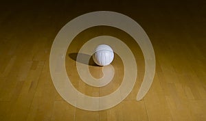 Volleyball court wooden floor with ball on black with copy-space