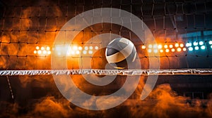 A volleyball floating over the net amid a dramatic orange-hued atmosphere in an indoor arena photo