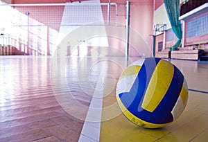 Volleyball in a gym on the floor clouseup