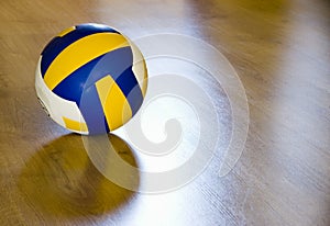 Volleyball on hardwood floor photo
