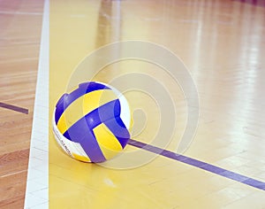 Volleyball on hardwood floor photo