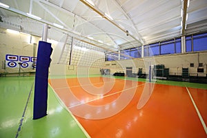 Volleyball net inside lighted school gym hall