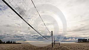 A volleyball net is stretched across a beach