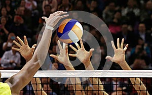 Volleyball spike blocking in front of  the net photo