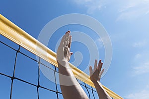 Volleyball spike hand block over net. close-up reach for ball
