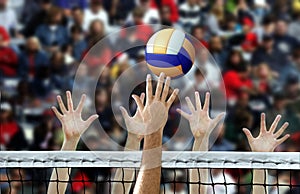 Volleyball spike with hands blocking over the net photo