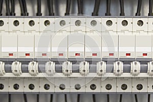 Voltage switchboard with circuit breakers.Wires and cables are connected to electrical equipment.
