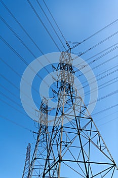 voltage transmission on electric tower. high-voltage on urban backdrop. powerful substation