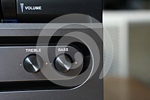 Volume, bass and treble knobs on an active speaker